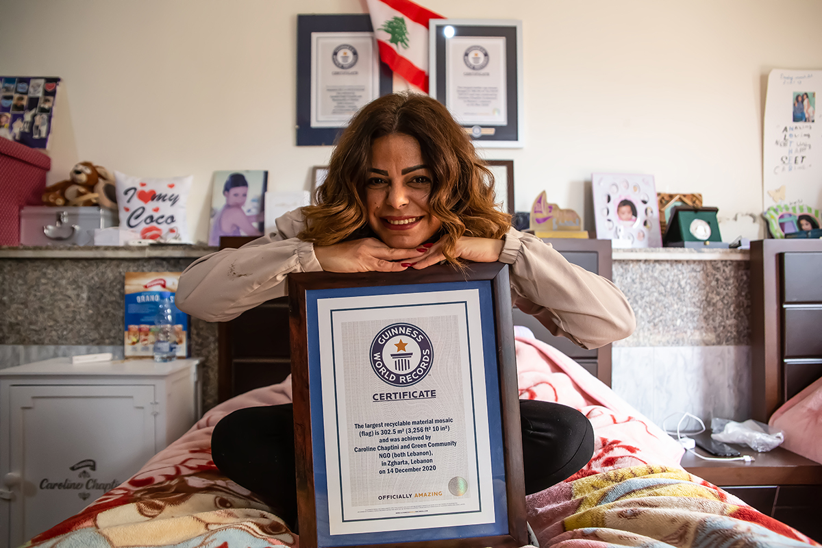 Caroline Chaptini holds her Guinness World Records certificate at her home in Lebanon. Photo: UN Women/Lauren Rooney