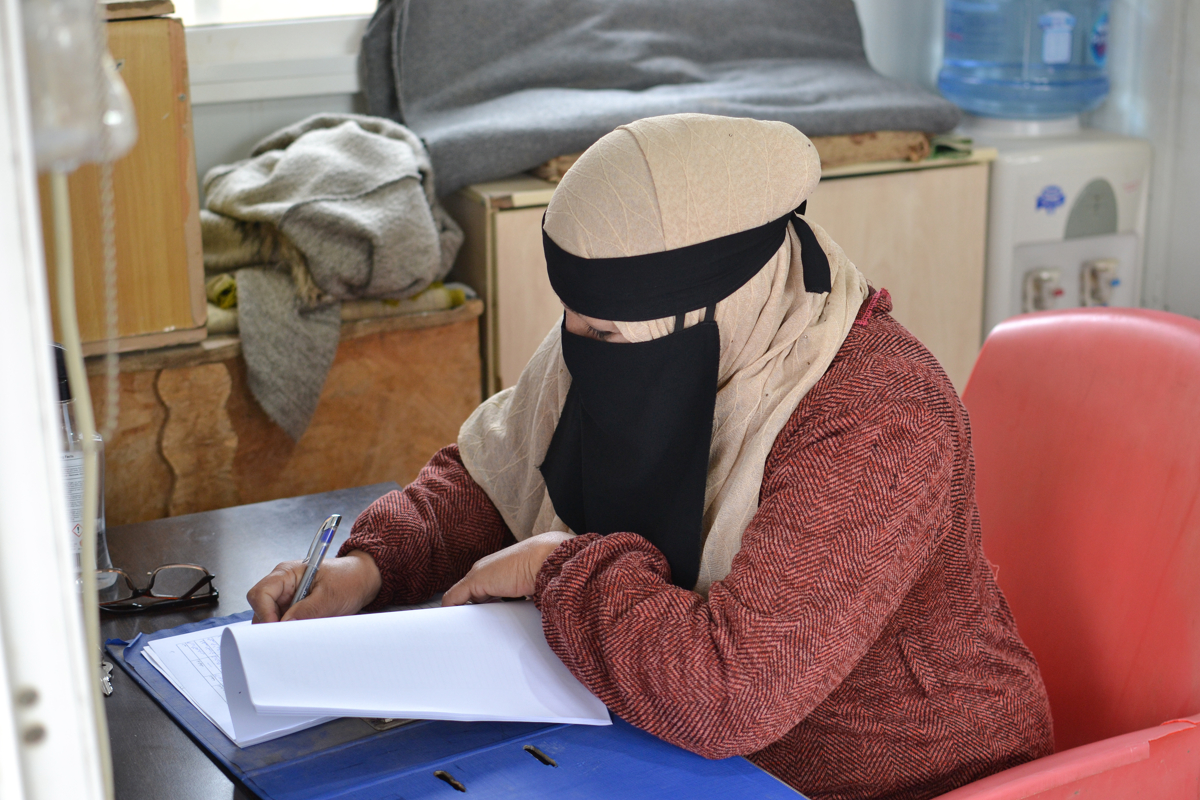 Fatima at the Zaatari Oasis centre taking notes as part of her tasks.