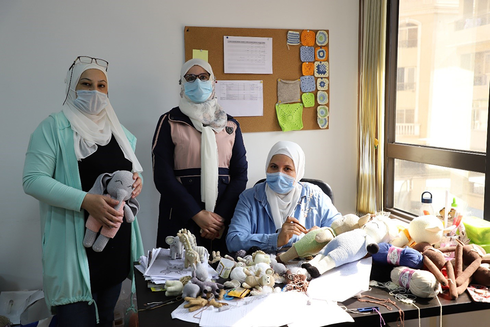 ElShalaby (in the middle) inside Vandi’s office along with her colleagues. Photo: UN Women/Mohamed AbdelHameed