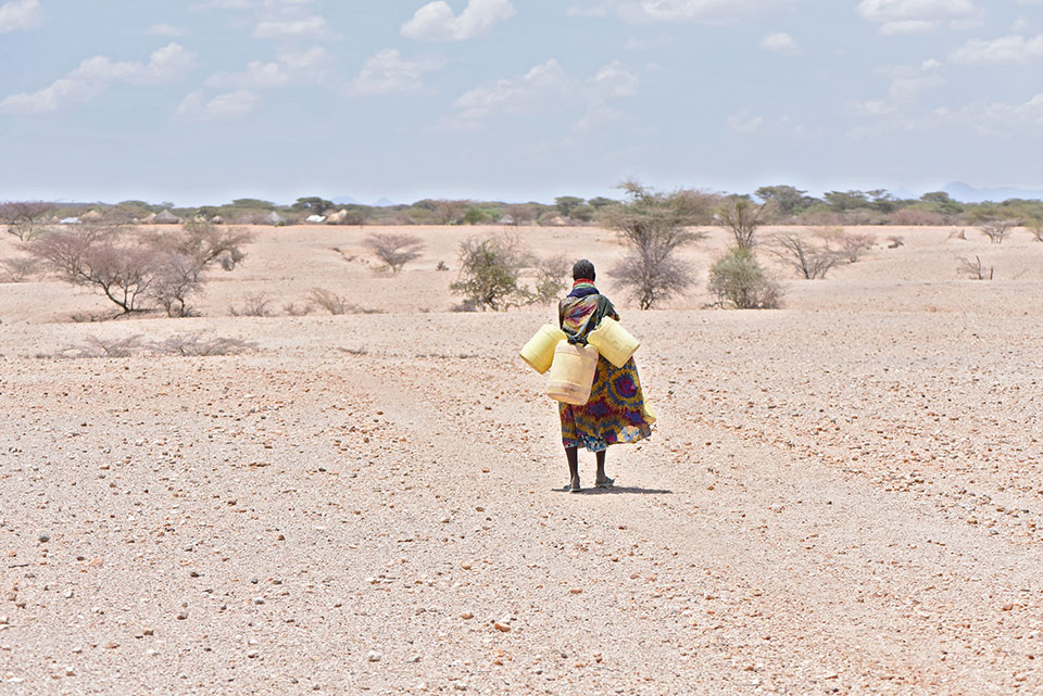 Adikor Lopunga Nangiro, farmer, Kenya, sets out to collect  water. Photo: UN Women/Kennedy Okoth