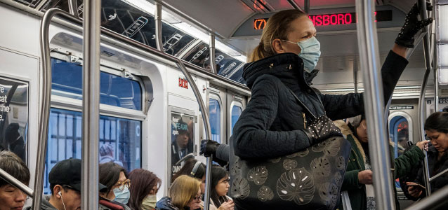 A woman on public transit in New York wears face mask in March 2020, when many appear to be doing so as a precaution against COVID-19. Photo: UN Photo/Loey Felipe