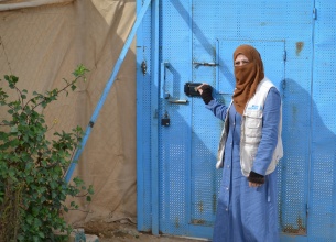 Samaher in front of the Zaatari Oasis centre gate where she works. 